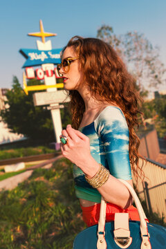 fashion conscious young woman walking in the city