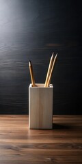 A sleek and modern minimalist desk with a simple wooden pencil holder