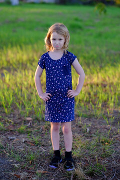 Girl with a frown and hands on hips