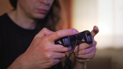 An engaged and precise mood is captured by a close-up of hands expertly manipulating a video game controller, with the player's face partially visible in the background