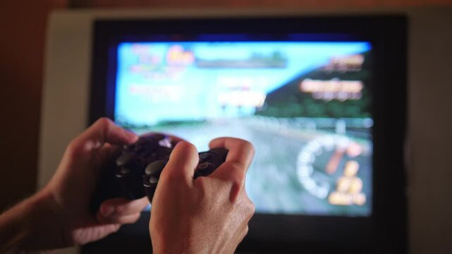An engaged and immersive mood is captured as hands expertly manipulate a game controller, with the blurred action of a video game visible on an older television screen in the background