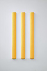 Fototapeta premium Three Vertical Yellow Sculptures on White Background