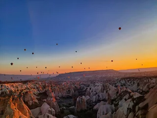 Fotobehang Chocoladebruin Hot Air Balloons in the Sunrise with beautiful sky over Goreme, Cappadocia, Turkey  © Thomas