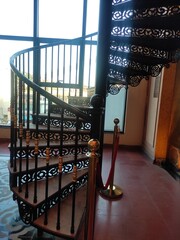 traditional spiral staircase with beautiful black railing 