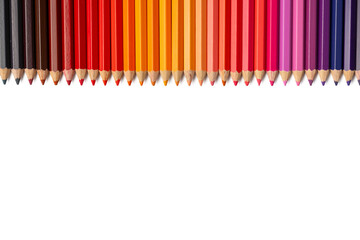 The Photo of colorful colored pencils arranged in a straight line against a white background.