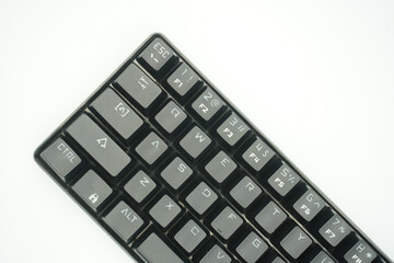 A mechanical keyboard with a 61% layout in black from the top with a white background.