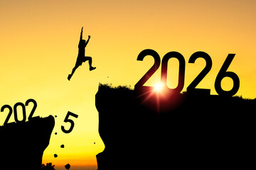 Welcome merry Christmas and happy new year in 2026,Silhouette Man jumping from 2025 cliff to 2026...