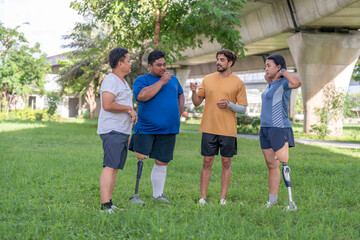 group of healthy multiracial friends including person with prosthetic legs talking and supporting together,gathering,exercise in garden
