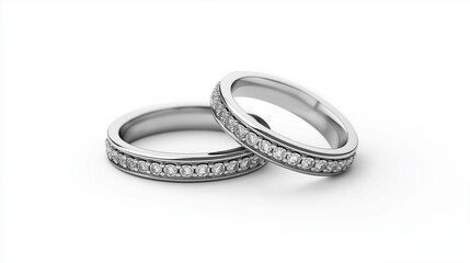 Two silver wedding bands with diamonds on a white background in a minimalist style close up view