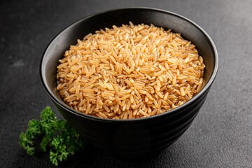 Brown rice whole grain cereal product superfood fresh tasty gourmet food background on the table rustic food top view copy space