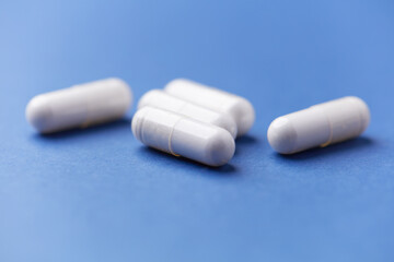 Arginine capsules on bright background. Soft focus. Close up. Copy space.	