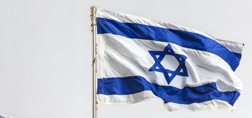 Israeli national flag waving on pole against bright sky, featuring blue stripes and Star of David as a symbol of national identity and pride