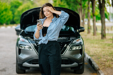 Naklejka premium A young woman stands by her car, feeling confused and anxious, and calls for help on the phone. The car won't start.