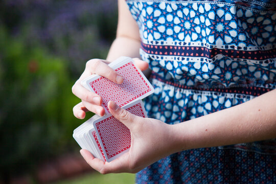 Teen girl shuffling a deck of cards