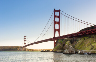 Golden Gate Bridge at sunset looking towards the Presidio of San Francisco from the opposite shore below the bridge