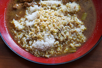 Rawon, Indonesia, captured on June 16, 2025. Traditional Indonesian home-cooked beef soup with black keluak nut broth, served with rice and simple side dishes.