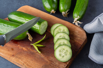 Fresh cucumber slices chopped on black  stone table
