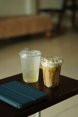 Closeup of Iced Caramel Macchiato at the coffee shop, Caramel Macchiato is a classic macchiato beverage. It consists of vanilla syrup, espresso, steamed milk, foam, and caramel drizzle