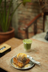 matcha and toast bread on the wood table