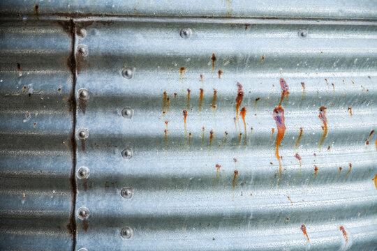 Rusted spots on a corrugated rainwater tank