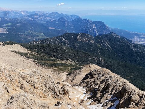 Panoramic view of the mountains and the coast of Kemer from the peak of Tahtali. Olympos Teleferik, Tahtali 2365m, Kemer, Antalya. Sea to sky.
