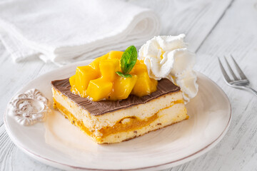 Square Mango Cheesecake With Chocolate Glaze, Fresh Cubes, and Whipped Cream