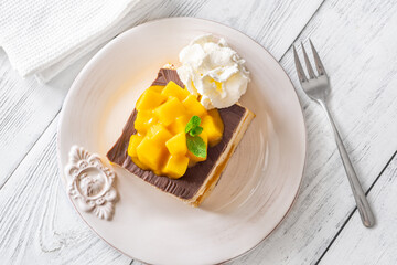 Square Mango Cheesecake With Chocolate Glaze, Fresh Cubes, and Whipped Cream