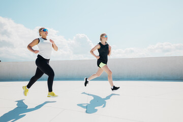 Energetic Runners Chase the Morning Sun on a Bright Urban Rooftop During Their Fitness Session in the City