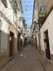 Obraz premium Decorated Narrow Street in a Mediterranean Town during Festival