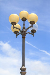 Modern round street lamps against blue sky