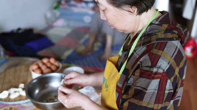 Making dumplings from scratch - squishing the dumpling dough to make the dumpling wrapper skins