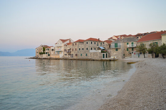 Traditional Dalmatian stone architecture, town Postira at sunset 