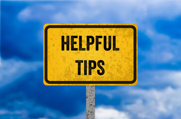 Helpful tips message written on yellow metal sign. Conceptual helpful tips symbol. Copy space.