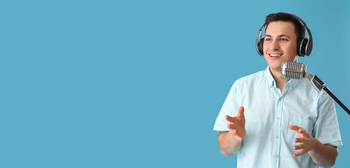 Male radio presenter with microphone on blue background with space for text