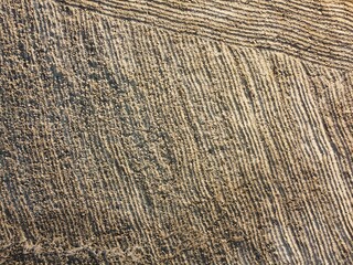 Fototapeta premium Patterns of sand created by tide changes on a beach in the early morning light