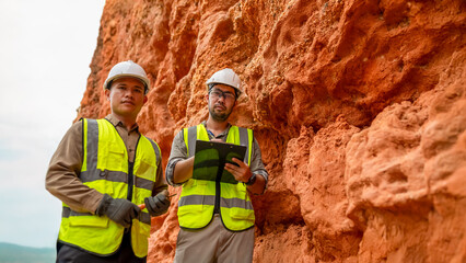 Two geologists examine minerals in the soil