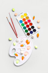 Decorative Easter eggs, watercolors and palette on white background. Easter concept.