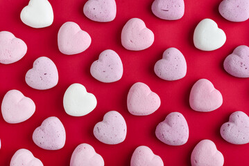 Multicolor heart marshmallows on red background