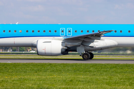 Embraer 195 KLM airplane taxiing on runway at Amsterdam Airport Schiphol in Netherlands