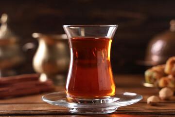 Glass of Turkish tea on wooden background