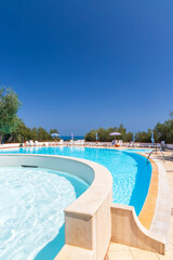 Inviting swimming pool with clear blue water reflecting summer sky