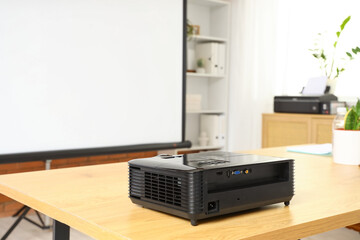 Modern projector on table in conference hall, closeup