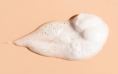 Abstract white foam texture on peach background