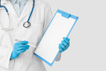 Female cardiologist with stethoscope pointing at clipboard on white background, closeup