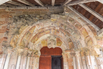 Fototapeta premium Ancient portal of the Saint Jean Baptiste abbey church showing weathered sculptures in Sorde l'Abbaye, France