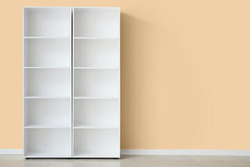 Empty white shelf unit near beige wall in room