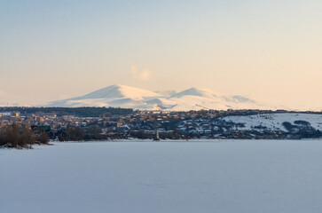 ice-covered Tsovinar Lake and Menaksar Mountain scenic view in winter (Hrazdan, Armenia)