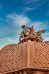 Obraz premium Statues atop a Dome at Sunset in Bucharest, Romania