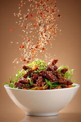 Szechuan-style spicy dish featuring colorful salad with sesame seeds. Concept of vibrant szechuan flavors highlighting spices and textures in presentation of well-crafted cuisine.
