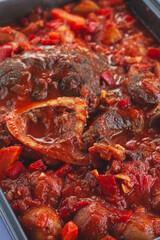 ossobuco stew with vegetables, knuckle on the bone with new potatoes, in tomato sauce,homemade, top view, no people,